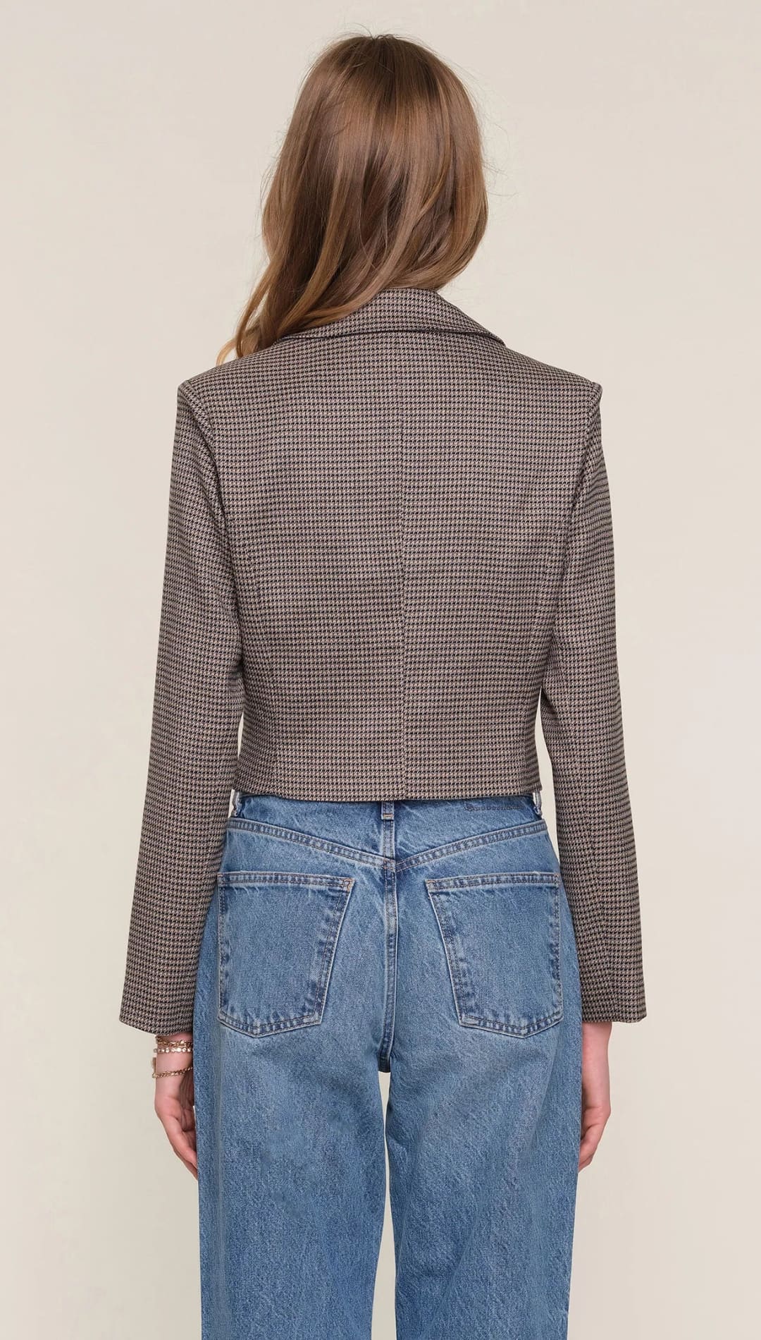 Brown and white checkered blazer with long sleeves.