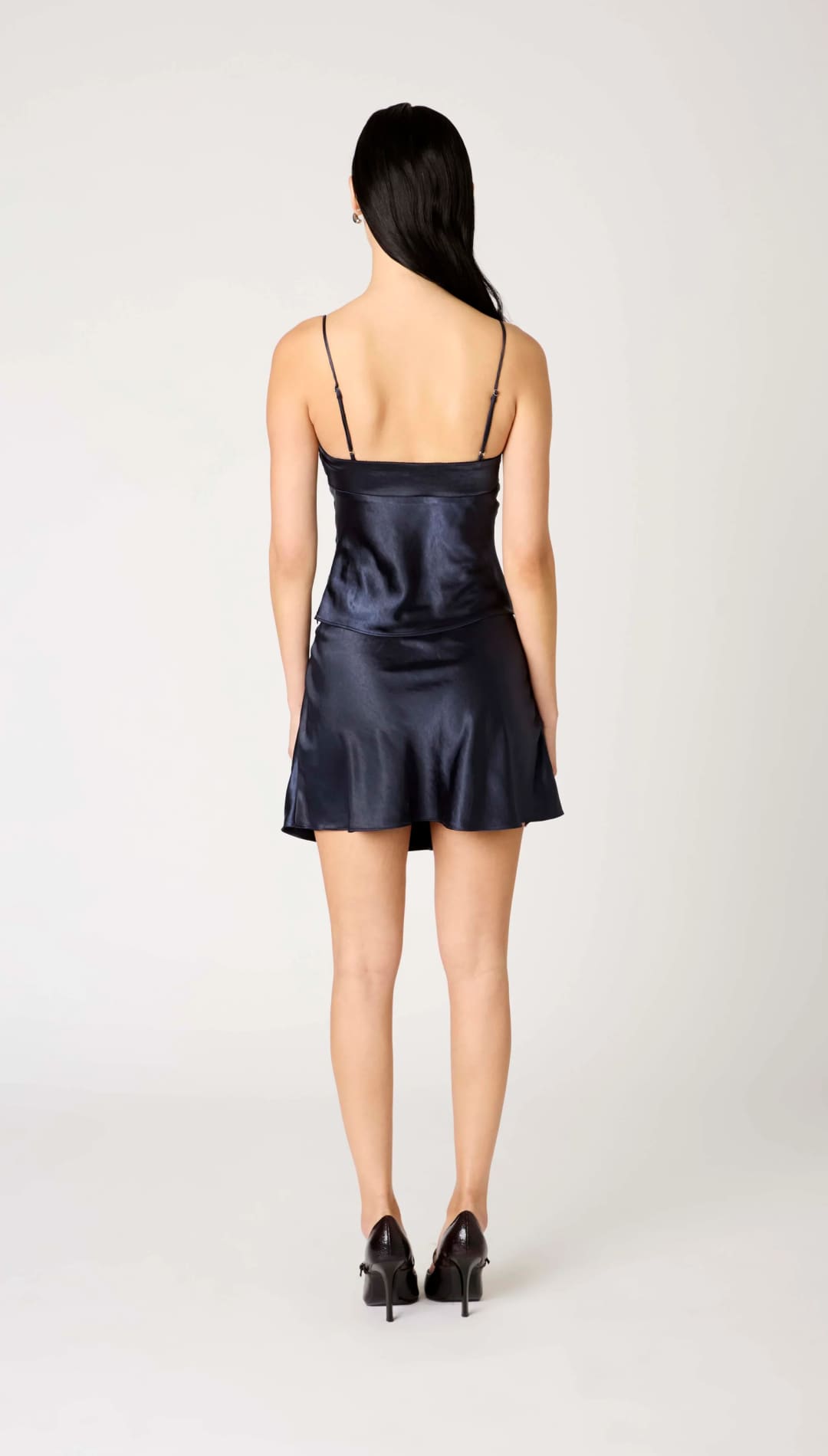 Navy blue satin slip dress with spaghetti straps.
