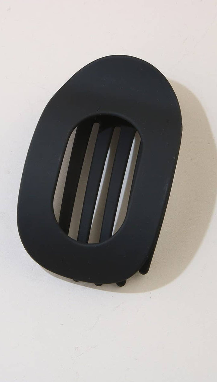 Black oval-shaped belt buckle with horizontal slits and textured edges.