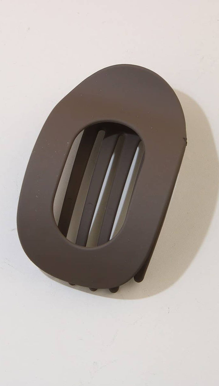 Brown leather belt buckle with oval shape and slotted design for easy fastening.