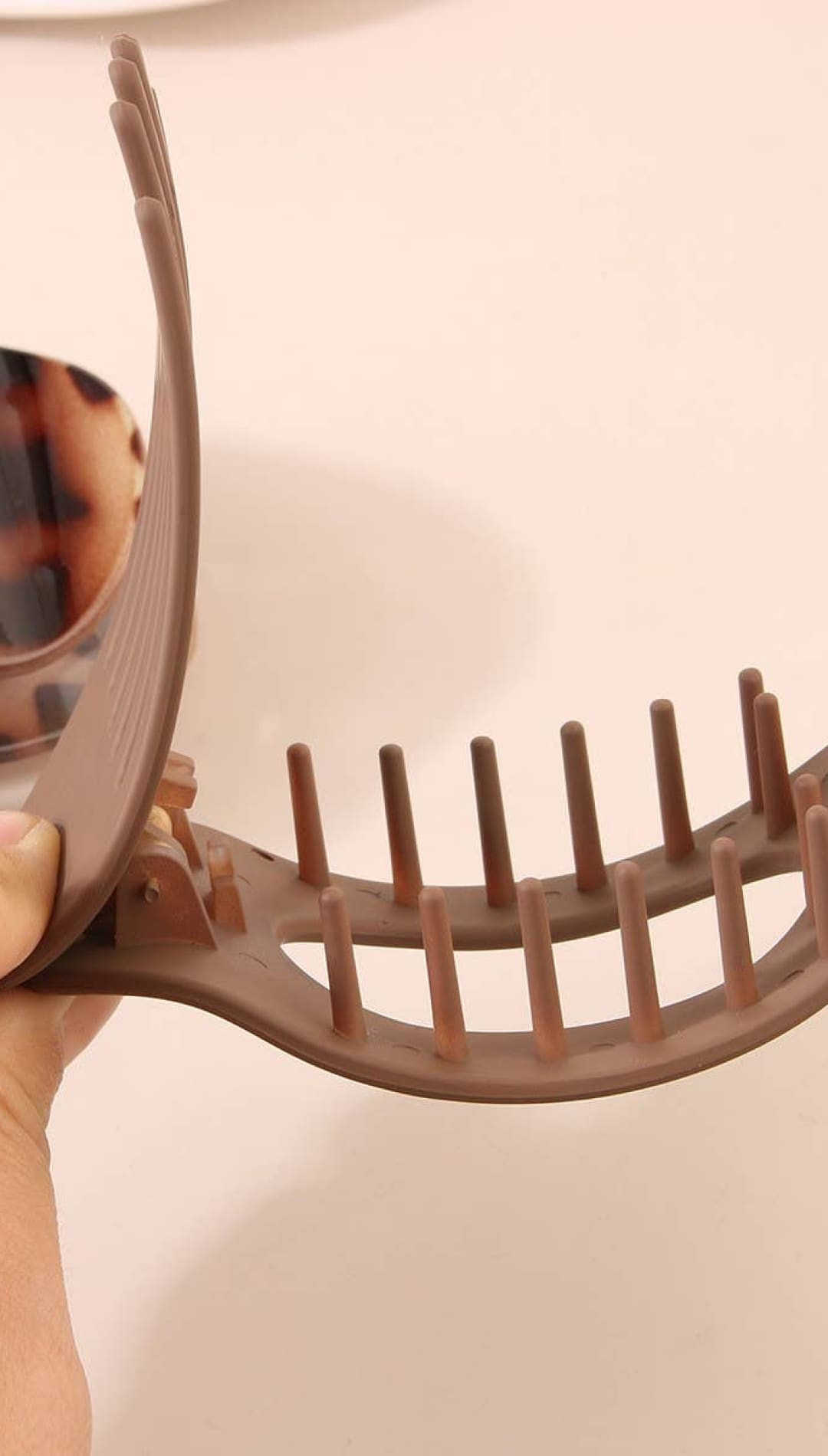 Leopard print hair clip with brown comb design, plastic material.