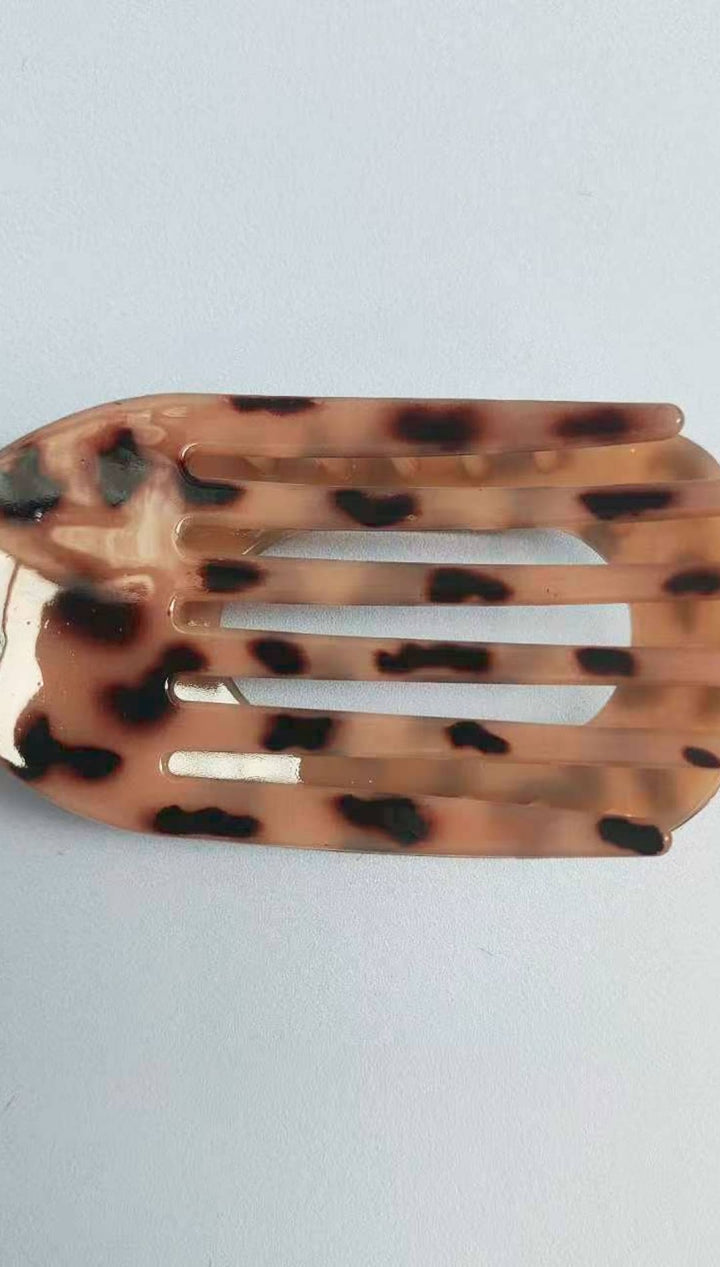 Leopard print hair clip with tortoiseshell accents.
