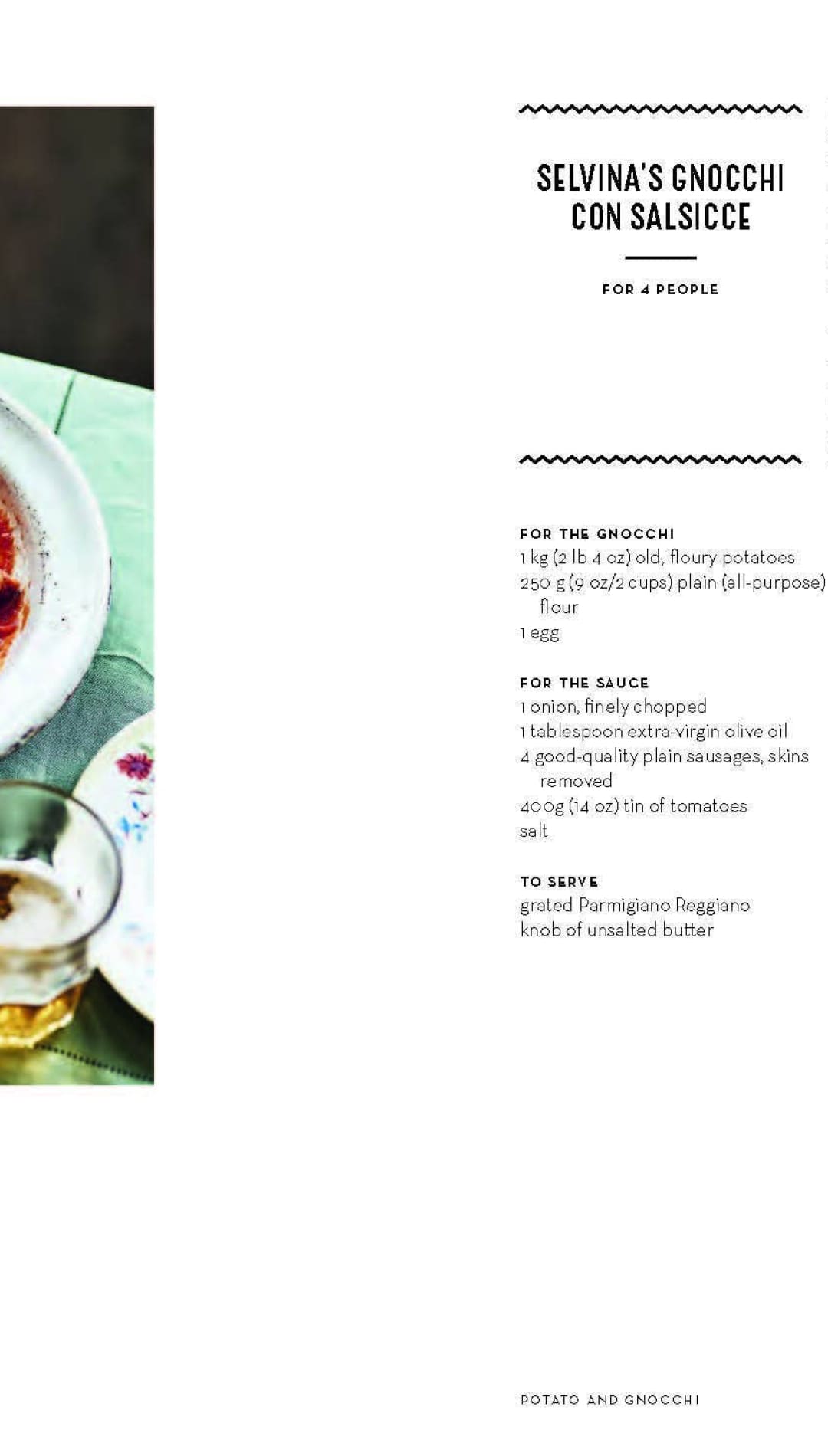 White bowl with red sauce and shrimp, green napkin underneath.