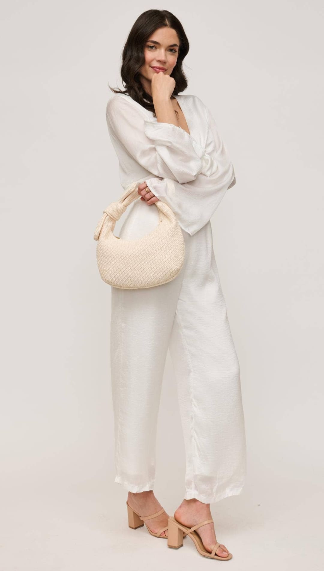 Cream-colored, rounded handbag.