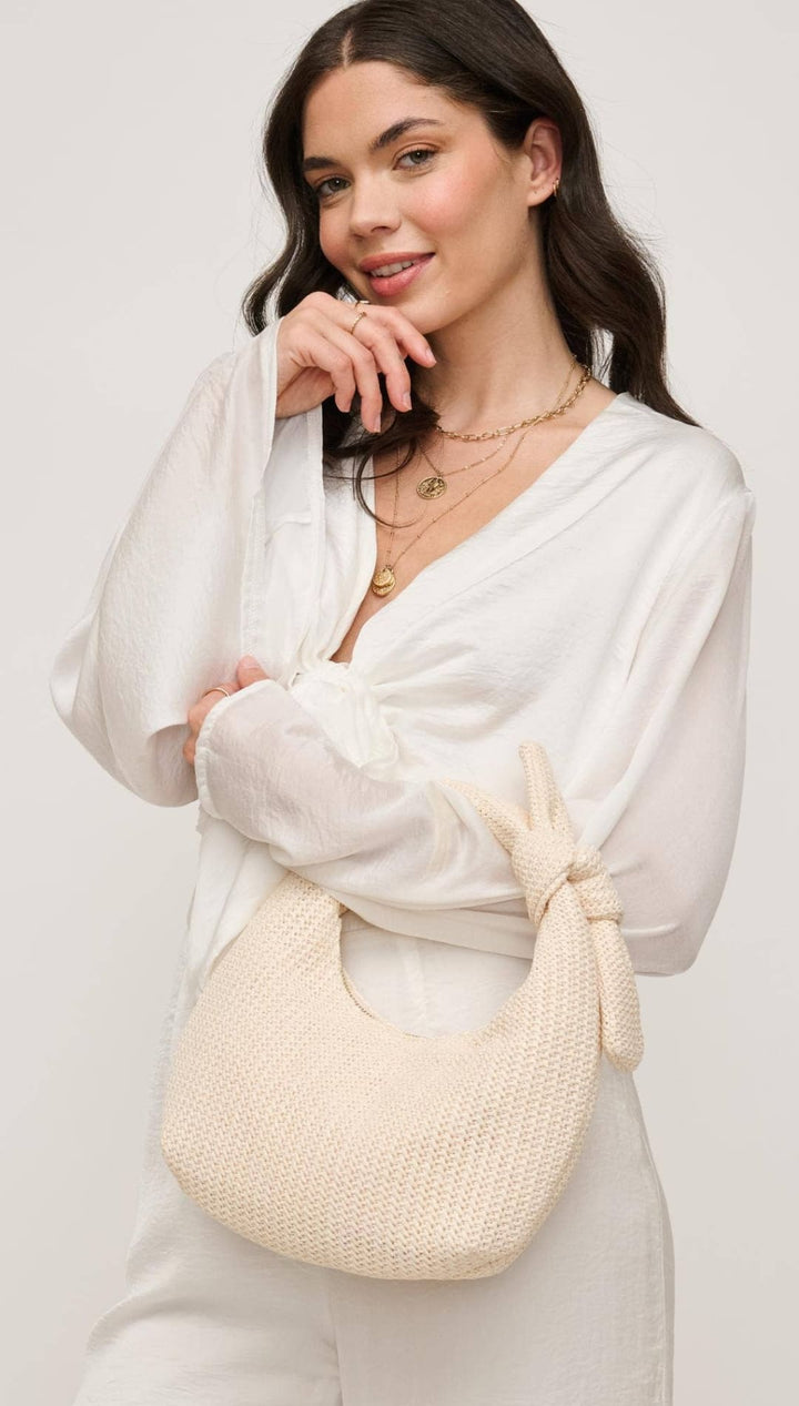 Cream-colored woven handbag.