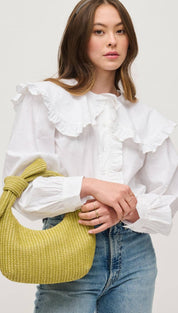 Yellow woven handbag with knotted handle.