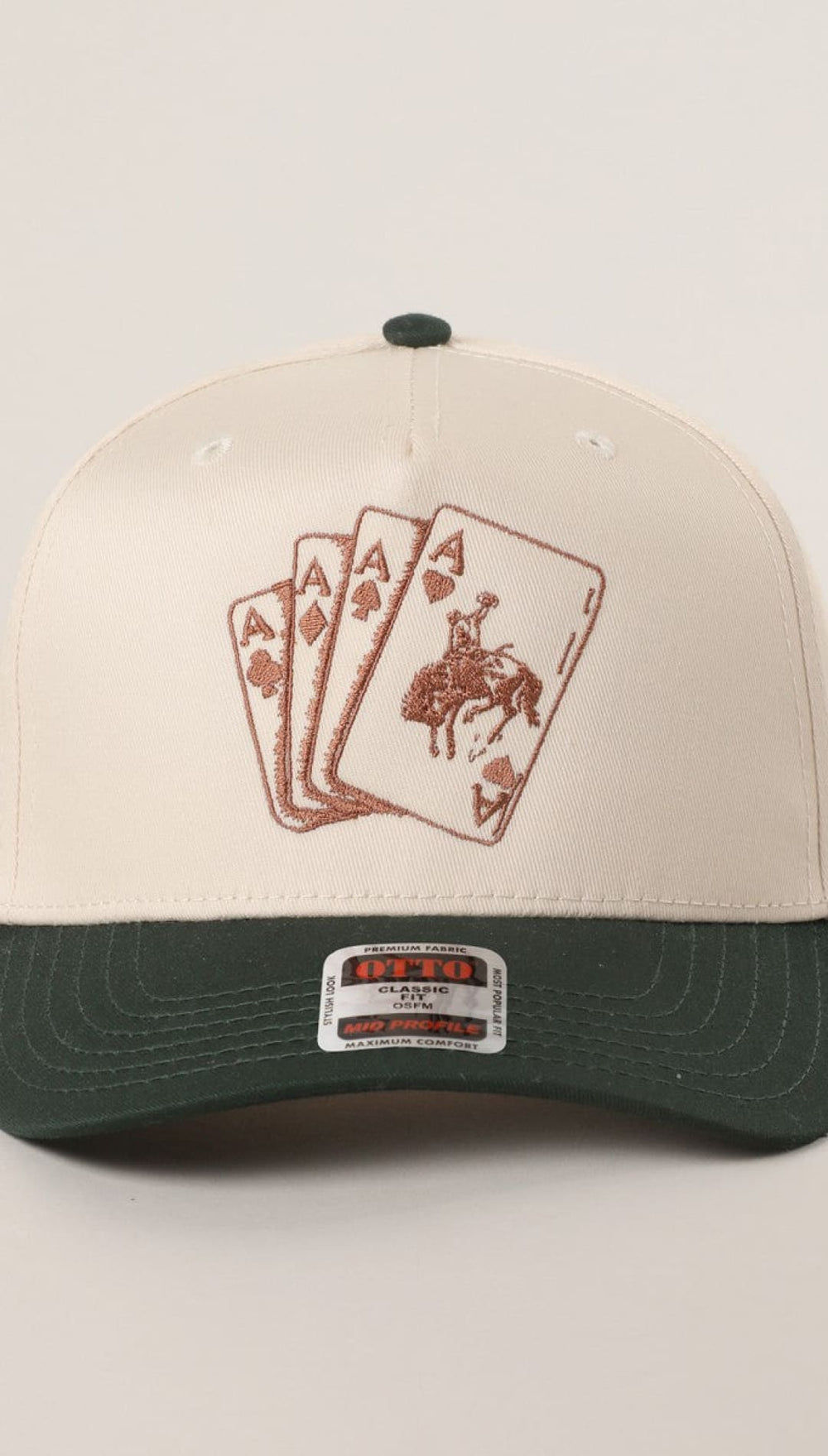 Cowboy hat with three aces design, cream and green brim, leather strap.