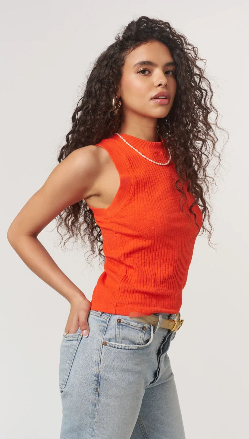 Woman in orange ribbed tank top.