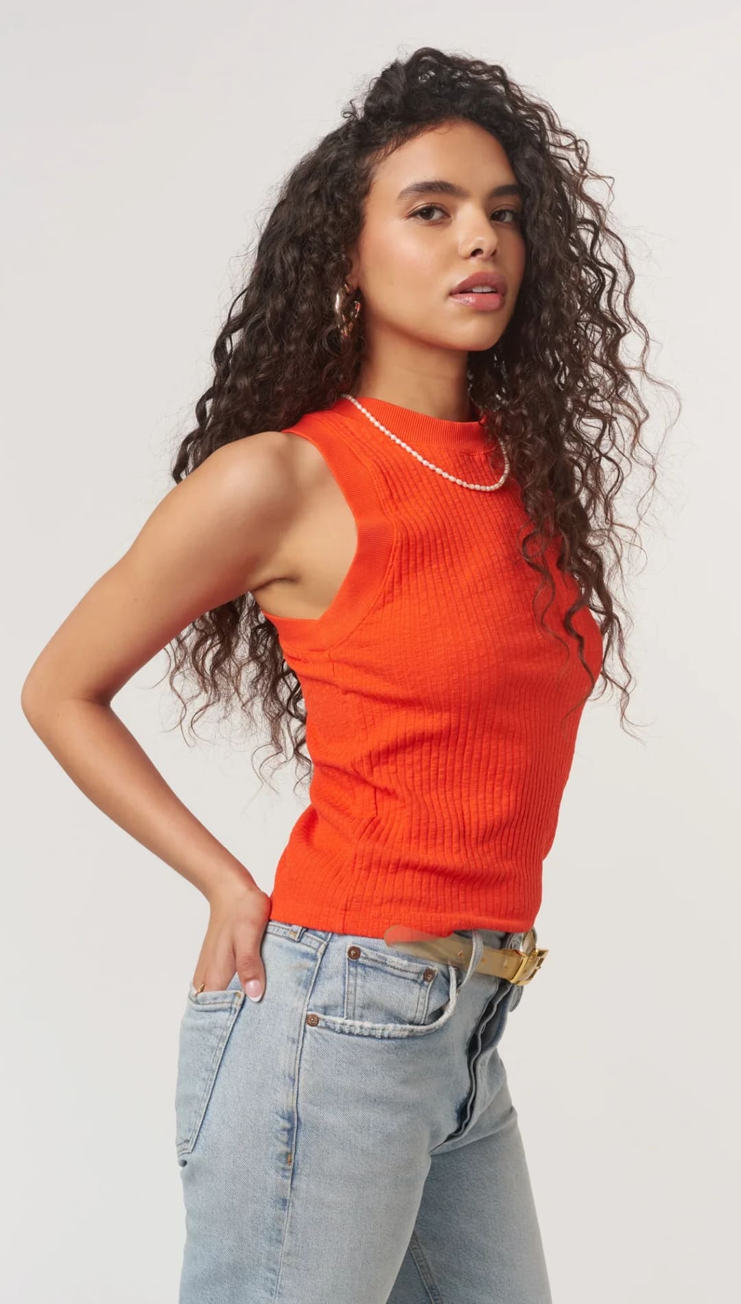 Woman in orange ribbed tank top.