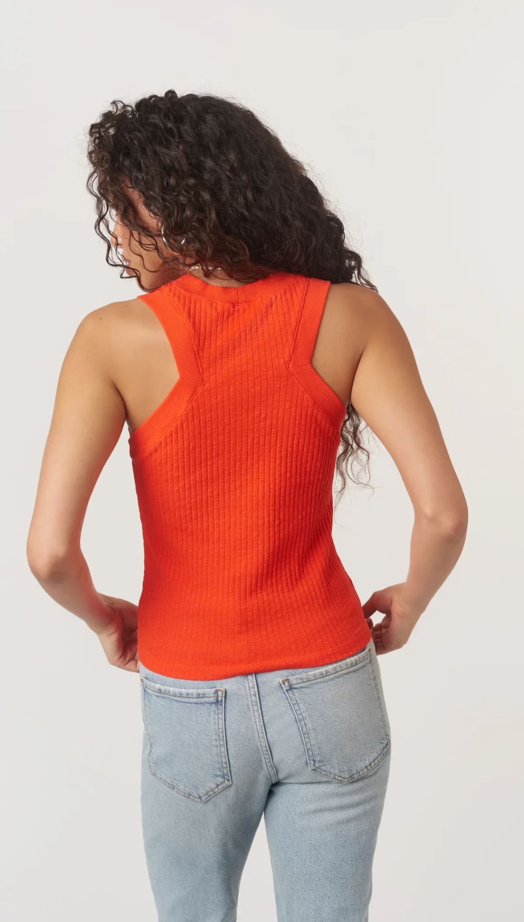 Woman’s orange ribbed tank top.