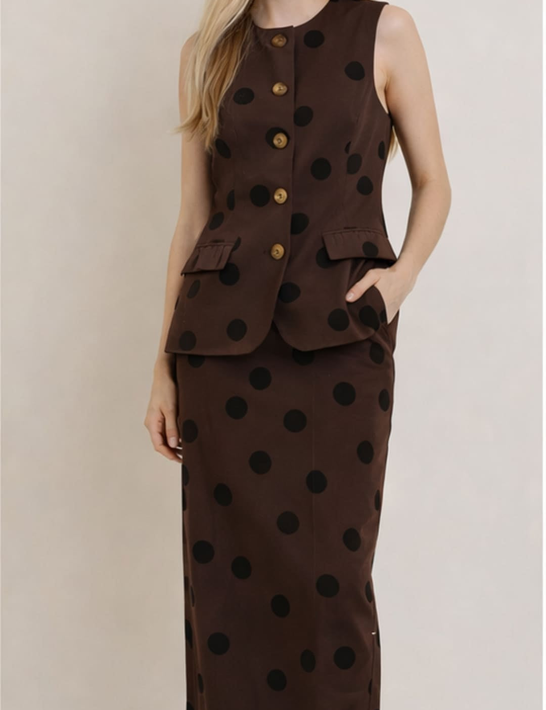 Brown sleeveless vest with black polka dots and gold buttons, paired with a matching skirt.