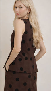 Brown sleeveless peplum top with black polka dots.