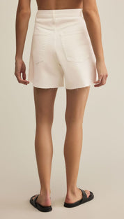 White denim shorts with frayed hems.
