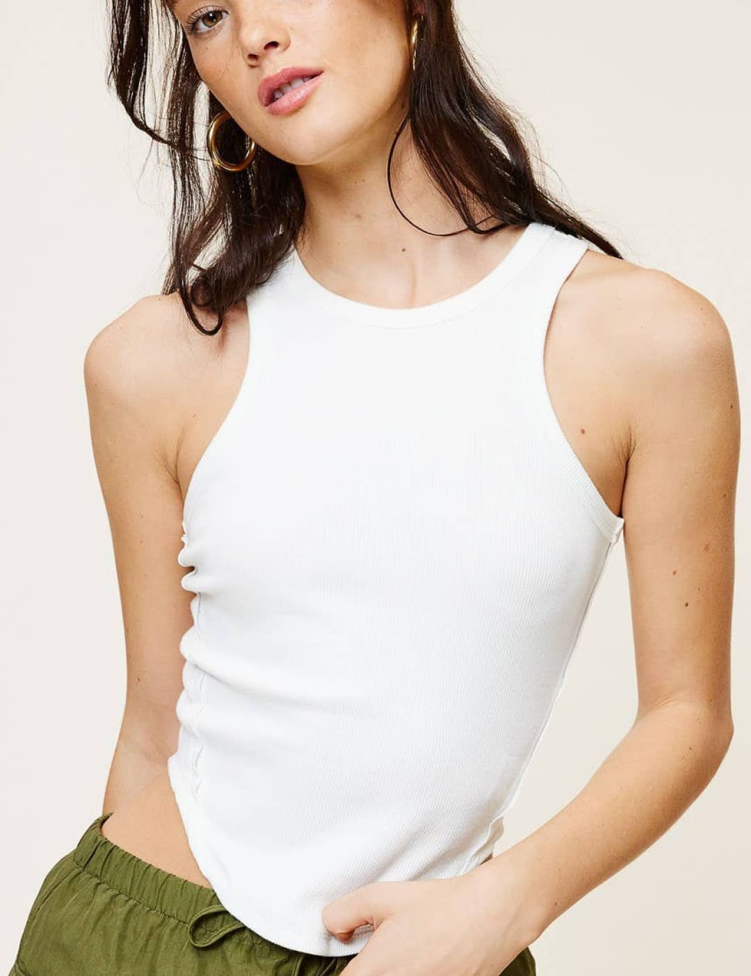 White ribbed tank top with a high neckline and fitted silhouette.