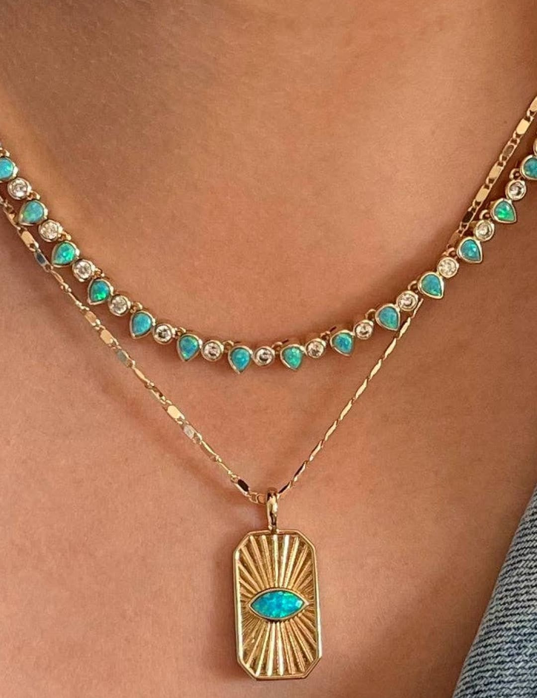 Layered gold necklaces with turquoise accents.