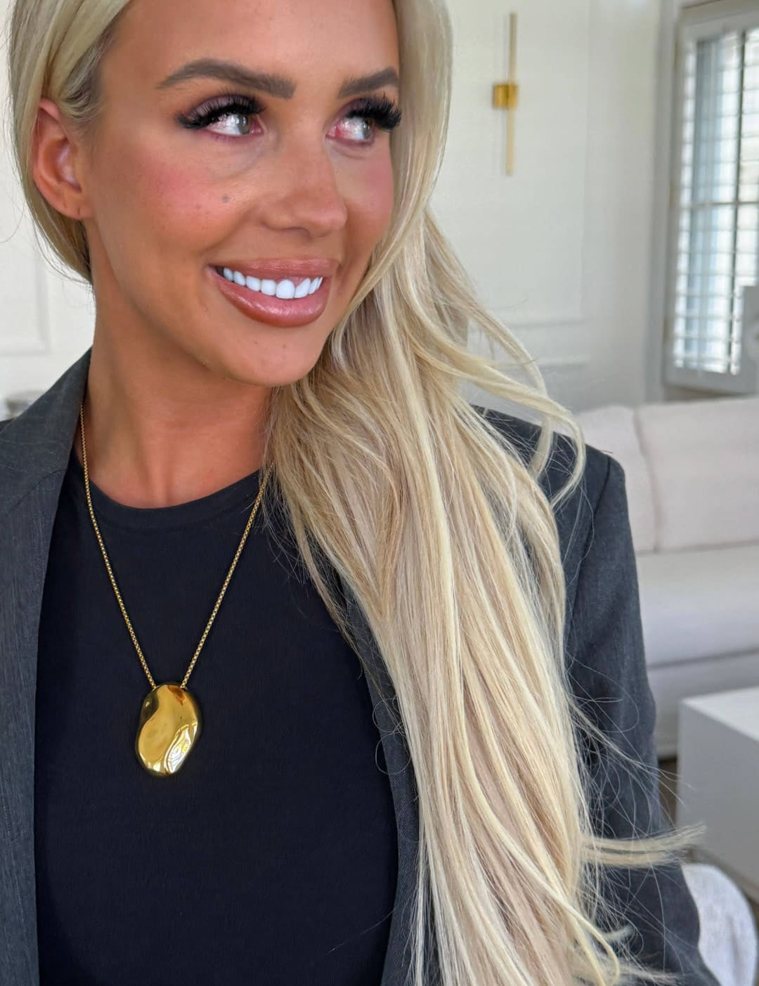 Gold oval pendant necklace with a delicate chain.