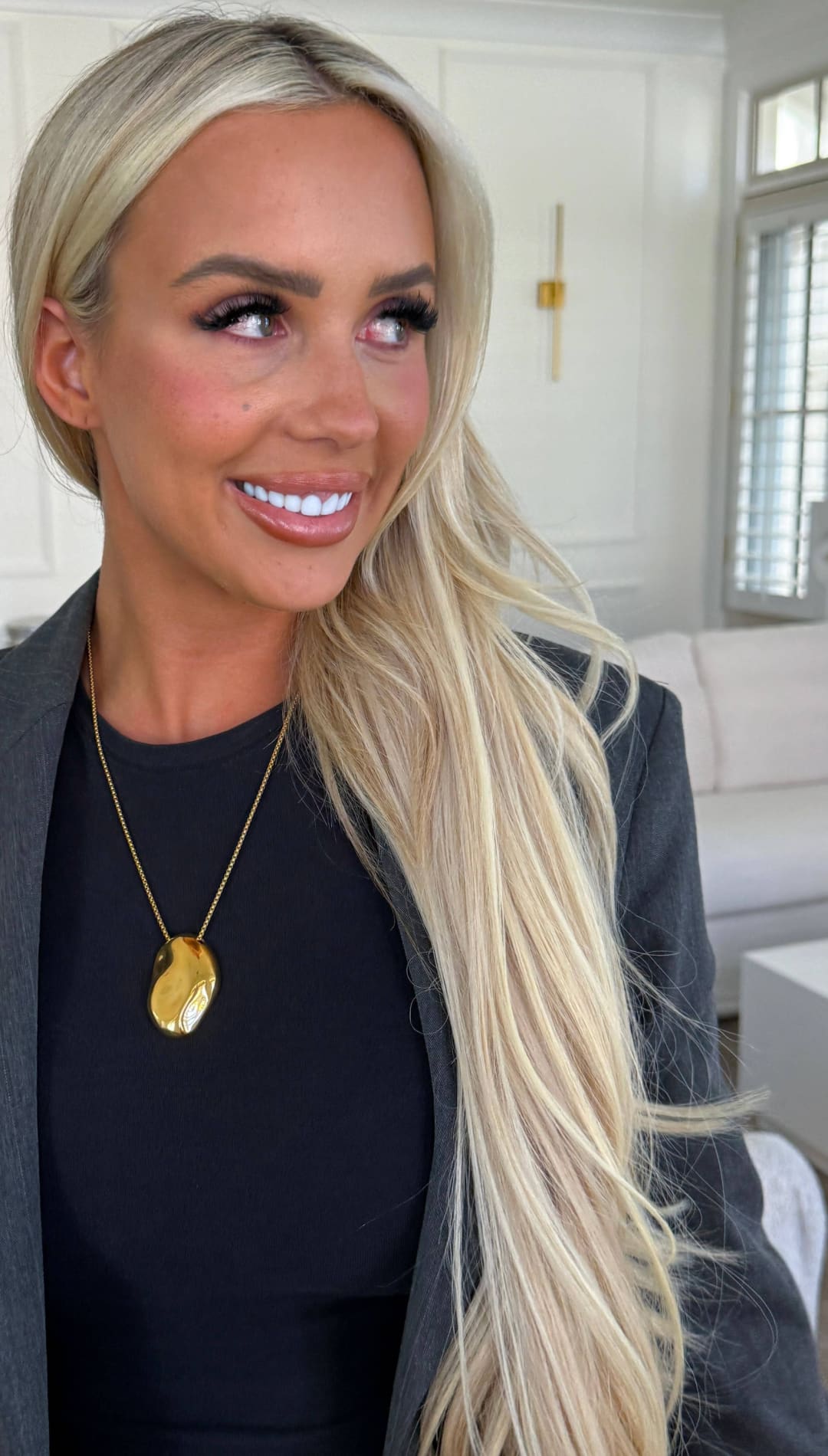 Gold oval pendant necklace with a delicate chain.