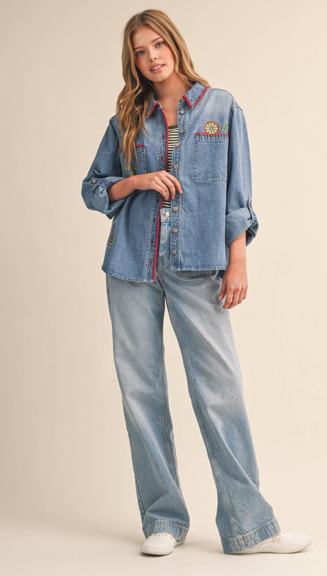 Light-wash denim button-up shirt with colorful embroidered details on the collar and chest pocket.