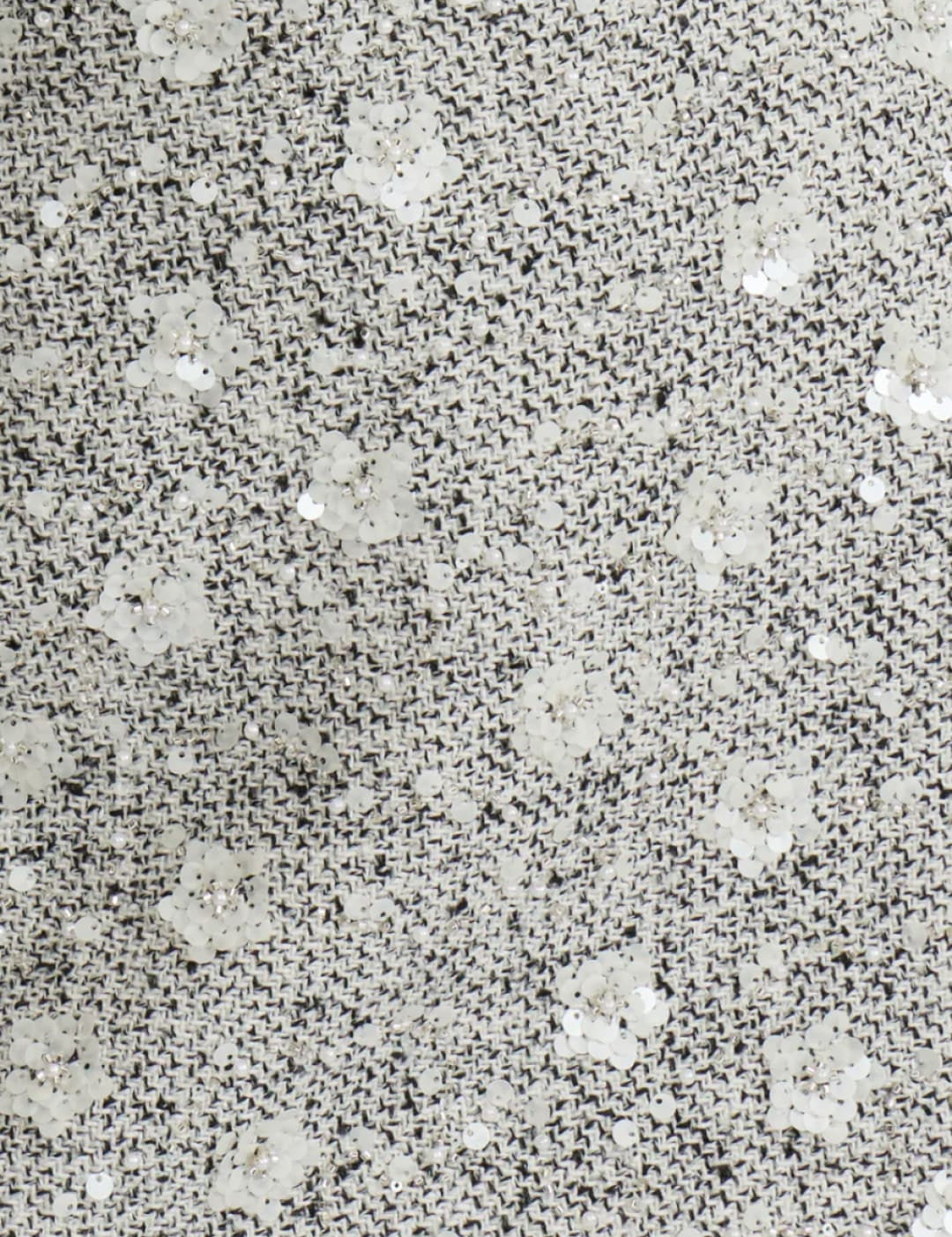 Silver sequin mini skirt with floral pattern and cutout hem.