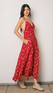 Red polka-dot maxi dress with thin straps and side pockets.