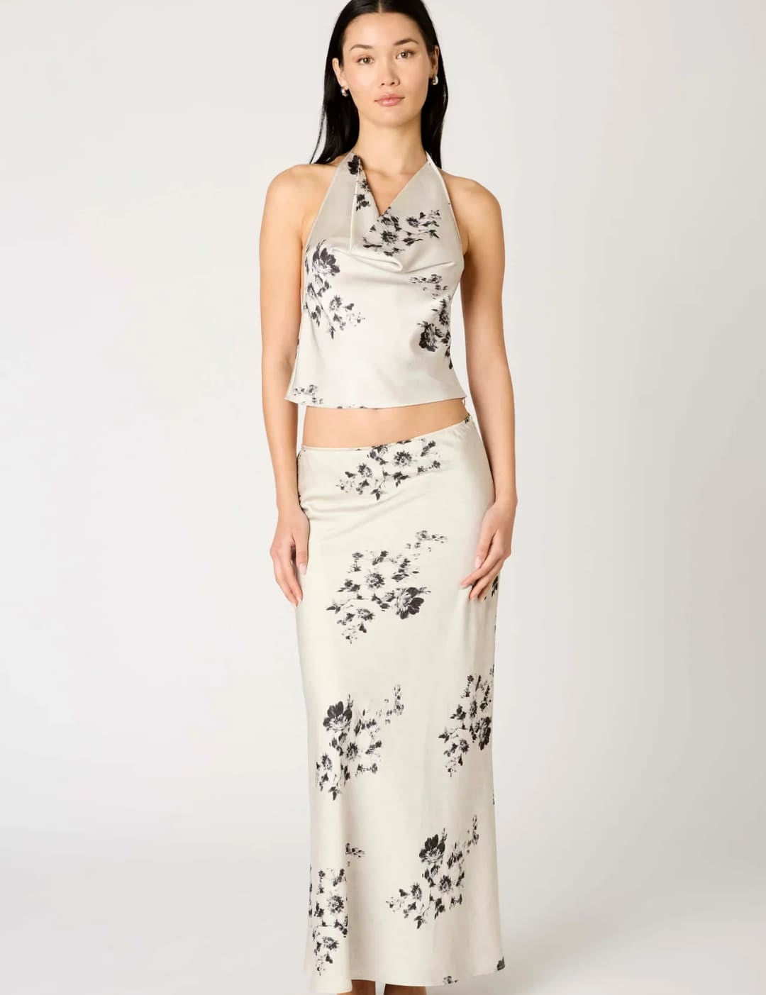 White floral print maxi skirt with black accents and a halter neck top set.