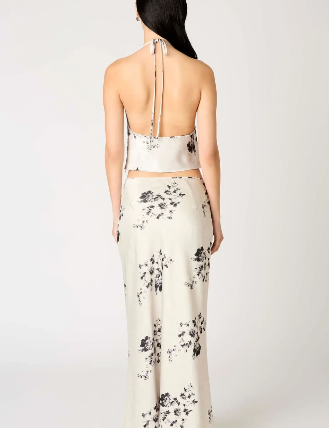 White floral print halter top and skirt set with black accents.
