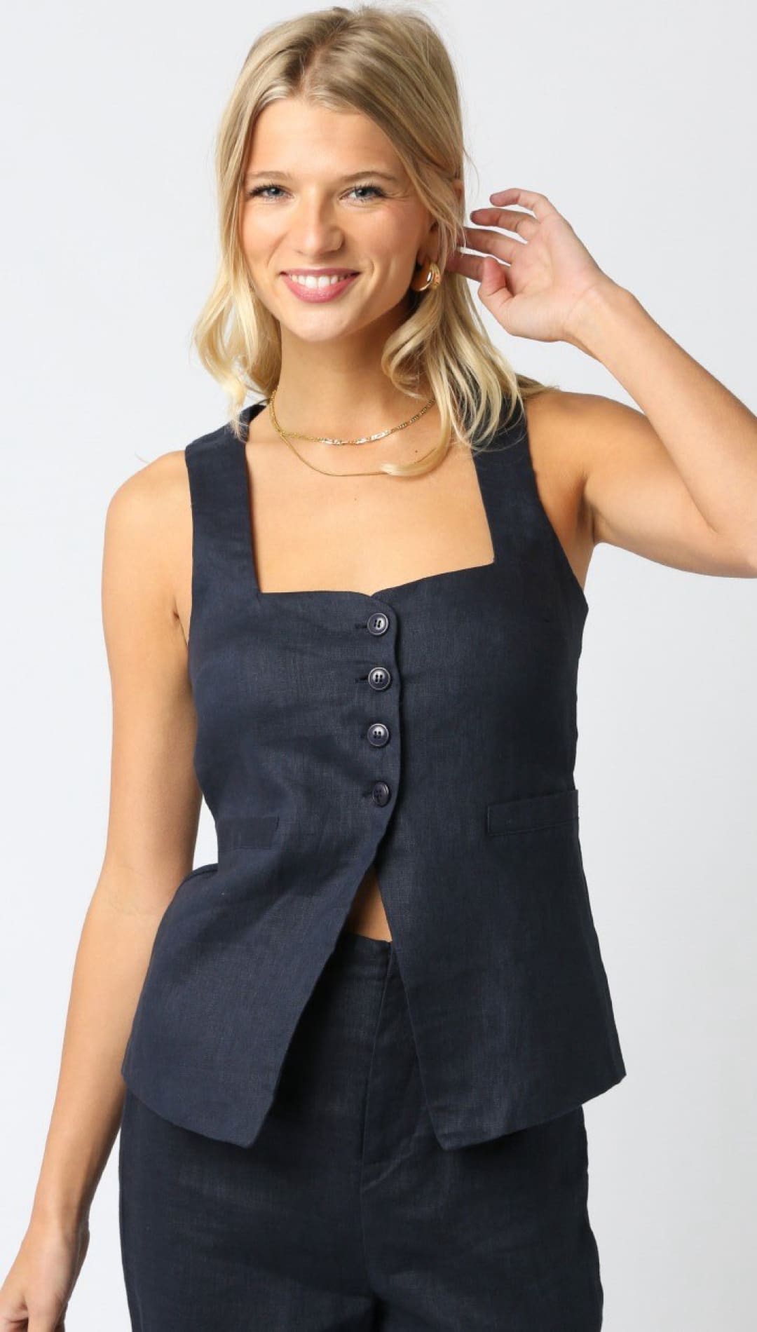 Navy button-front sleeveless top.