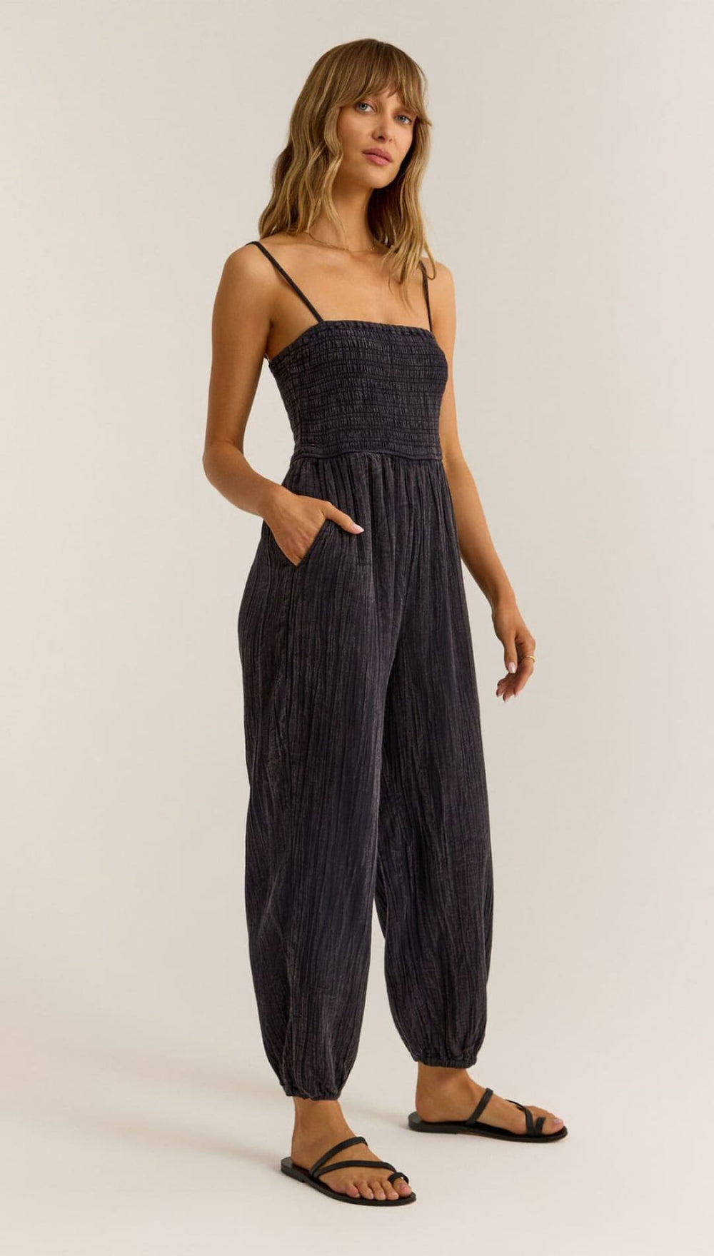 Black, strappy, crinkled jumpsuit.