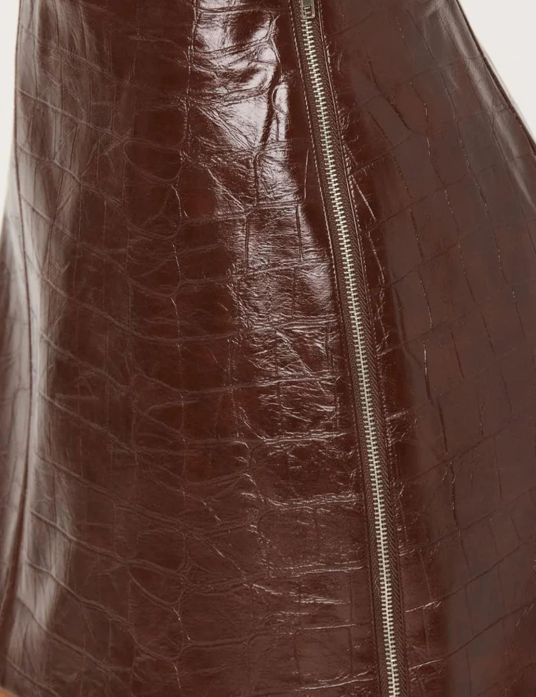 Brown crocodile-embossed faux leather mini skirt with a central front zipper.