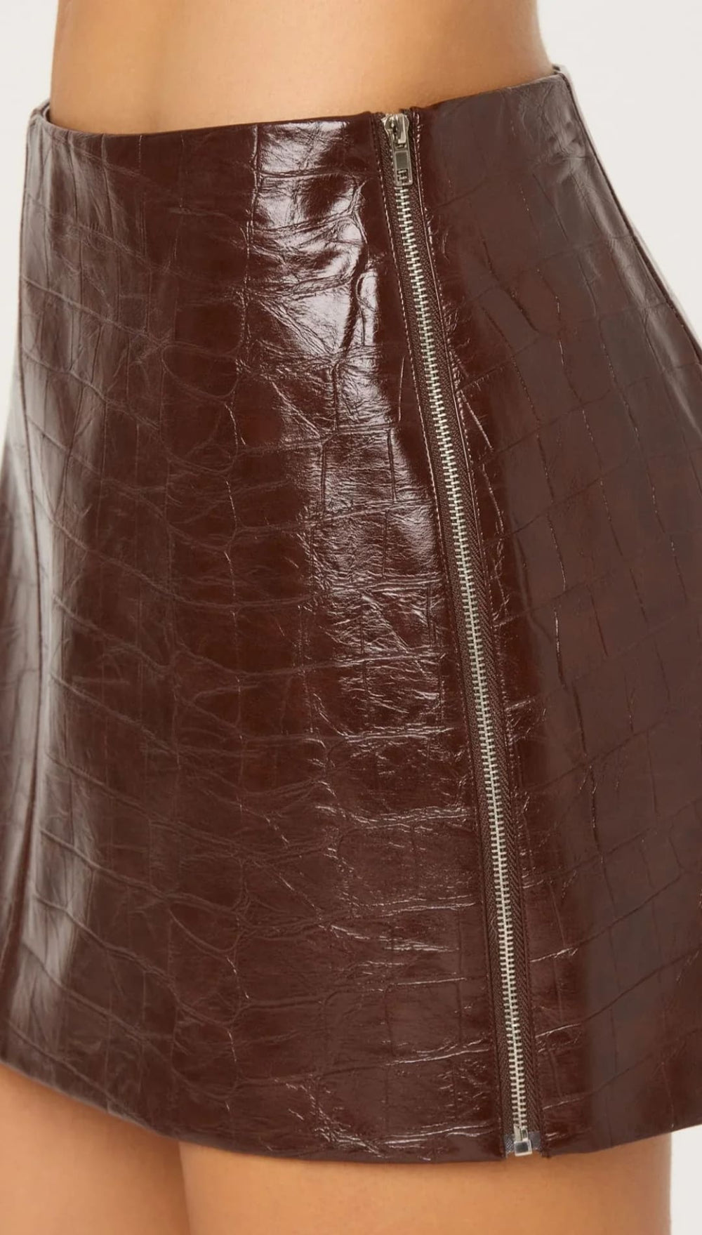 Brown crocodile-embossed faux leather mini skirt with a central front zipper.