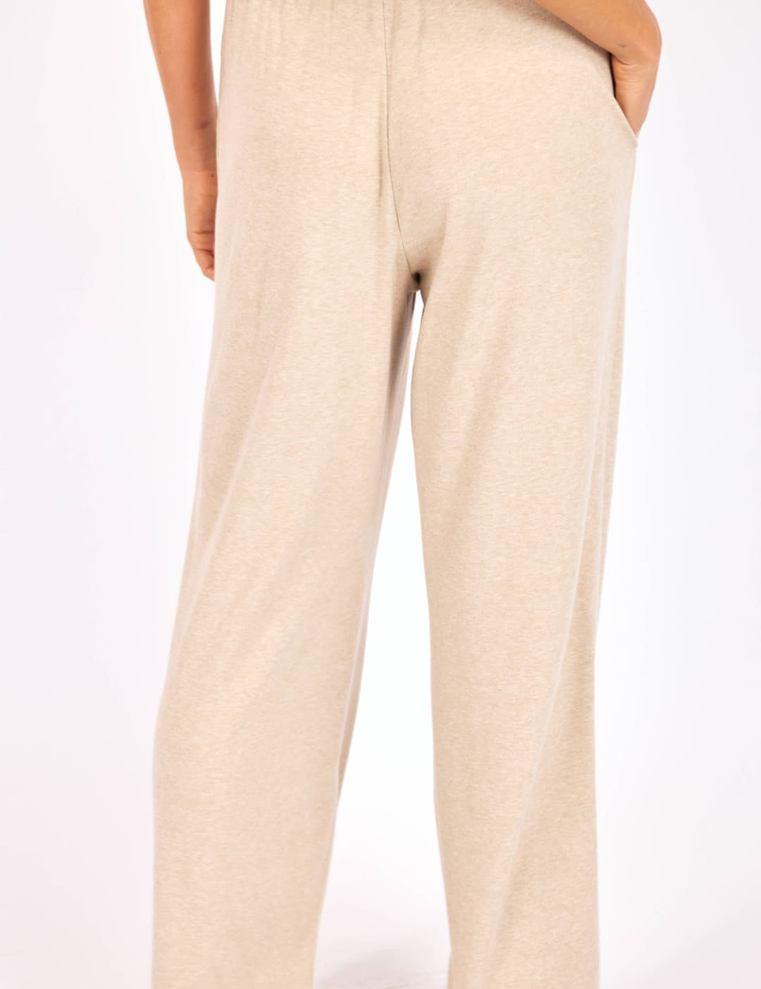 Beige wide-leg trousers with an elastic waistband and a relaxed, flowing silhouette.