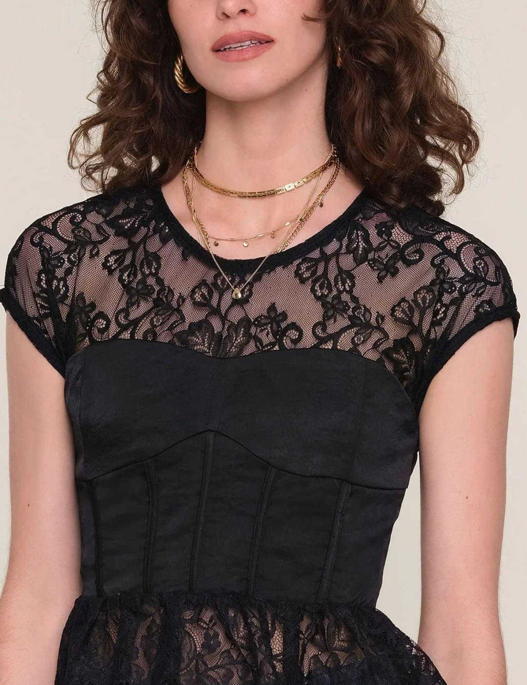 Black lace peplum top with gold chain necklace and jeans.