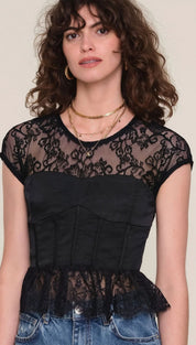 Black lace peplum top with gold chain necklace and jeans.