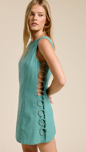 Teal sleeveless mini dress with a back panel featuring vertical metal rings.