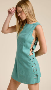 Teal sleeveless mini dress with a row of silver metal rings along the side seam.