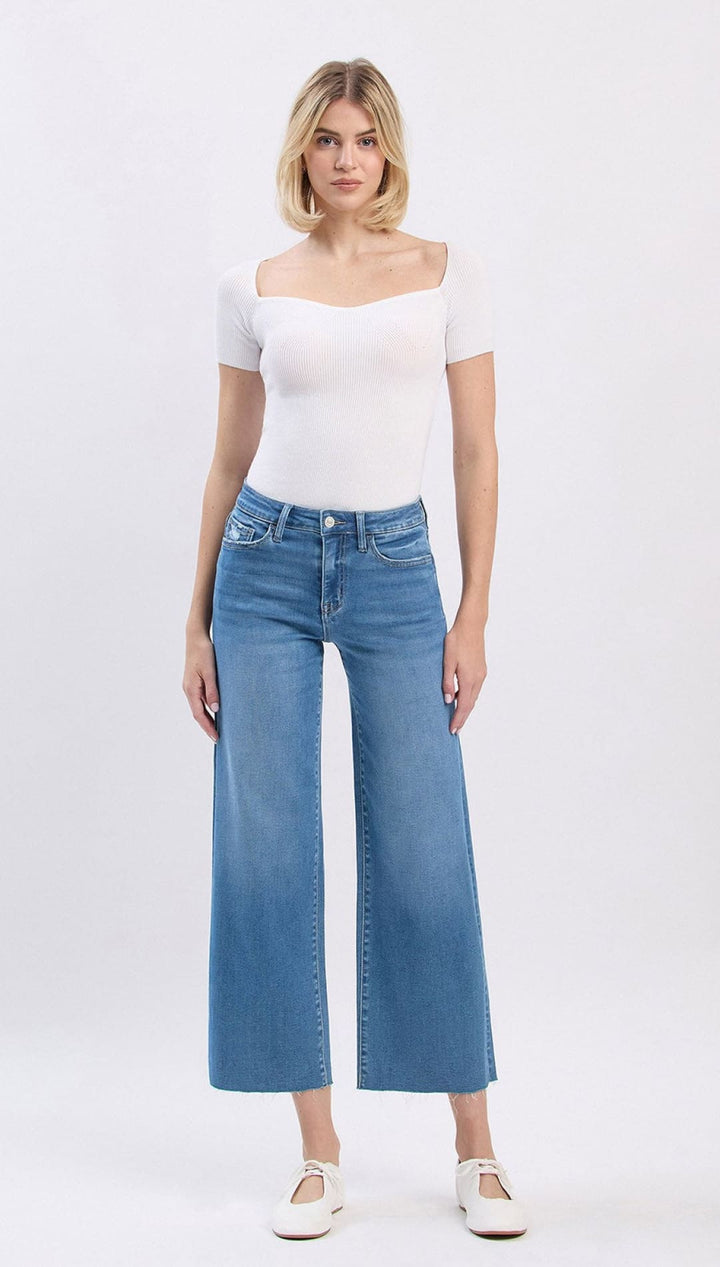 Wide-leg cropped jeans in light blue denim with white stitching and a high waistband, inspired by the levi’s 501 model.