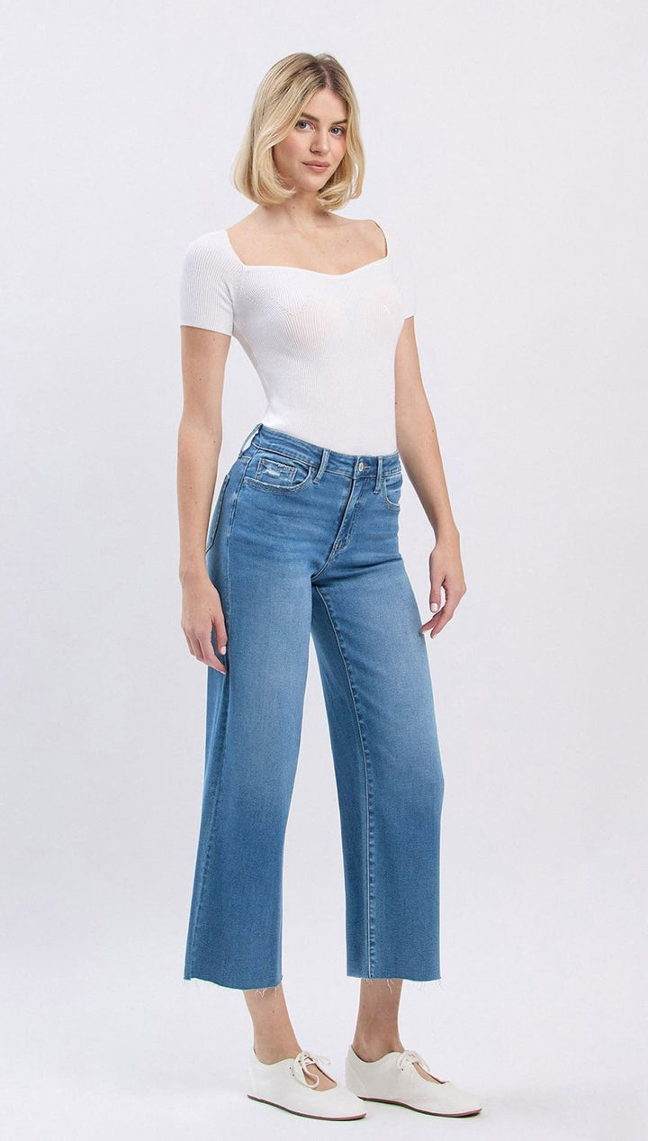 Blue high-waisted jeans with white stitching and a straight leg fit.