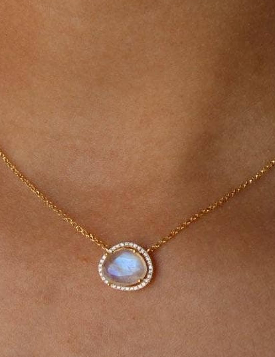 Gold necklace with moonstone pendant.