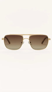 Gold-framed aviator sunglasses with brown gradient lenses.