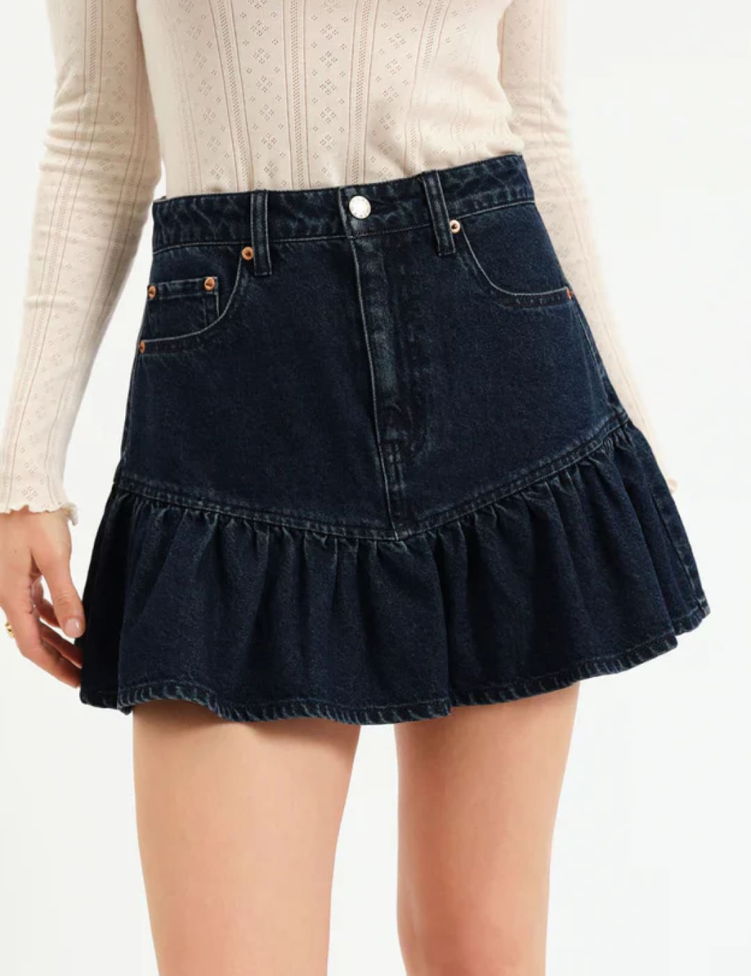 Dark denim ruffled mini skirt with button closure and elastic waistband.