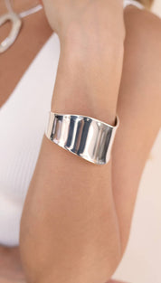 Shiny silver cuff bracelet.