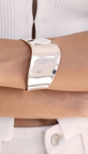 Shiny silver cuff bracelet.