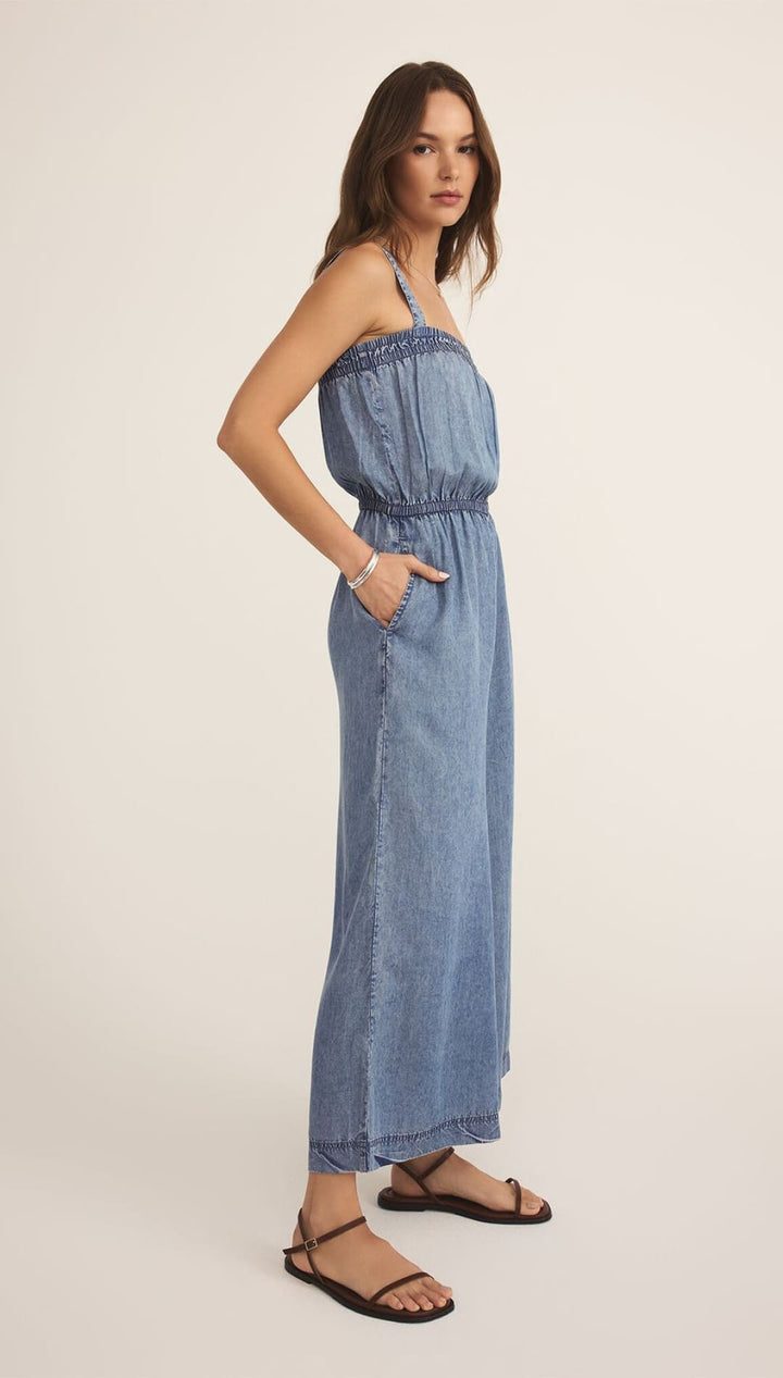 Denim jumpsuit with elastic waist.