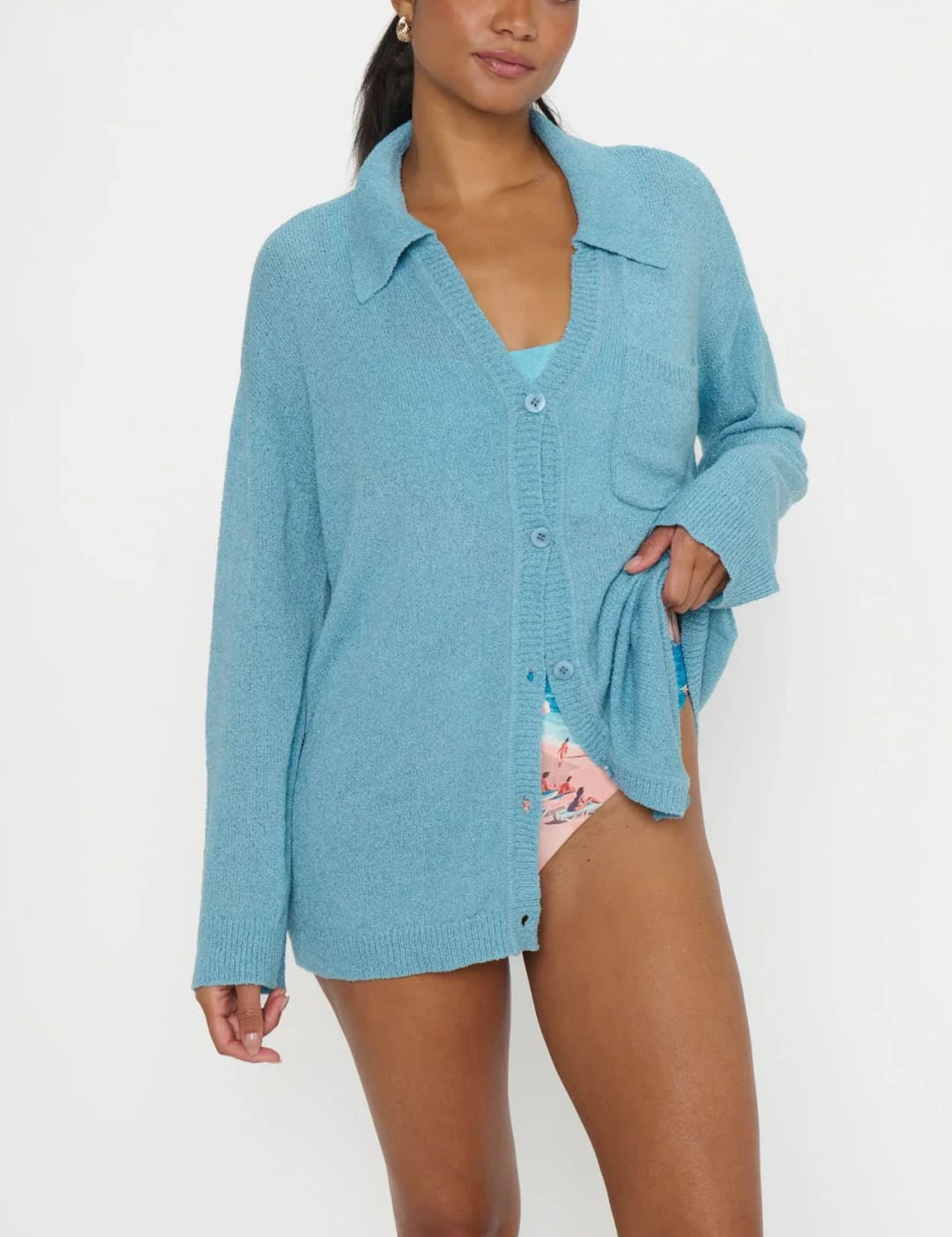 Light blue, oversized knit cardigan with button front and chest pocket.