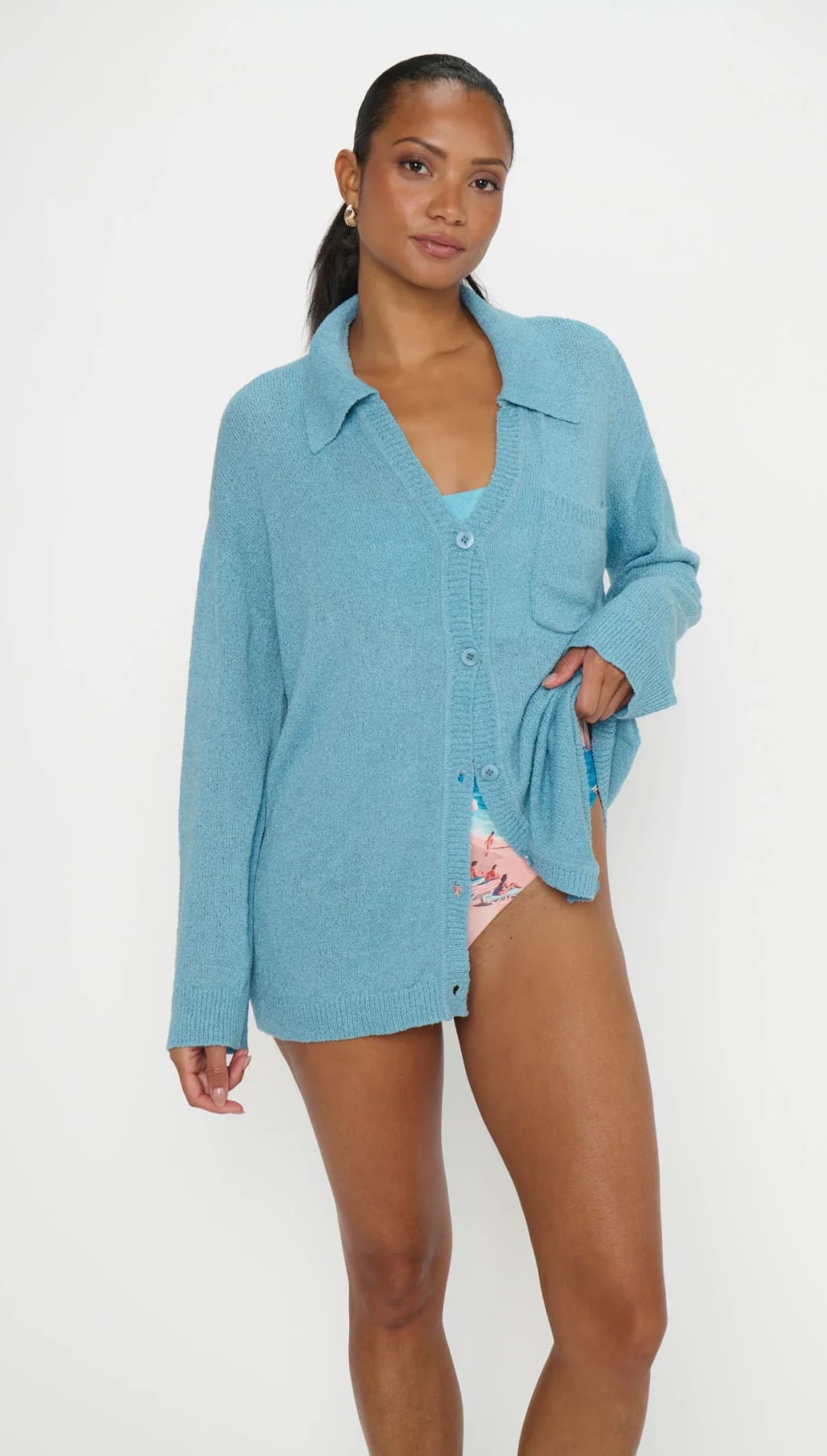 Light blue, oversized knit cardigan with button front and chest pocket.