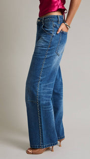 Blue denim wide-leg jeans with silver studs along the side seams.