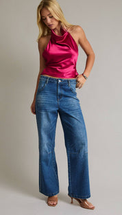 A vibrant fuchsia satin halter top with a sleek, high-neck design.