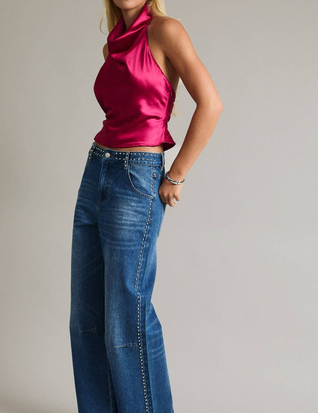 A vibrant fuchsia satin halter top with a cowl neckline and ruched back.