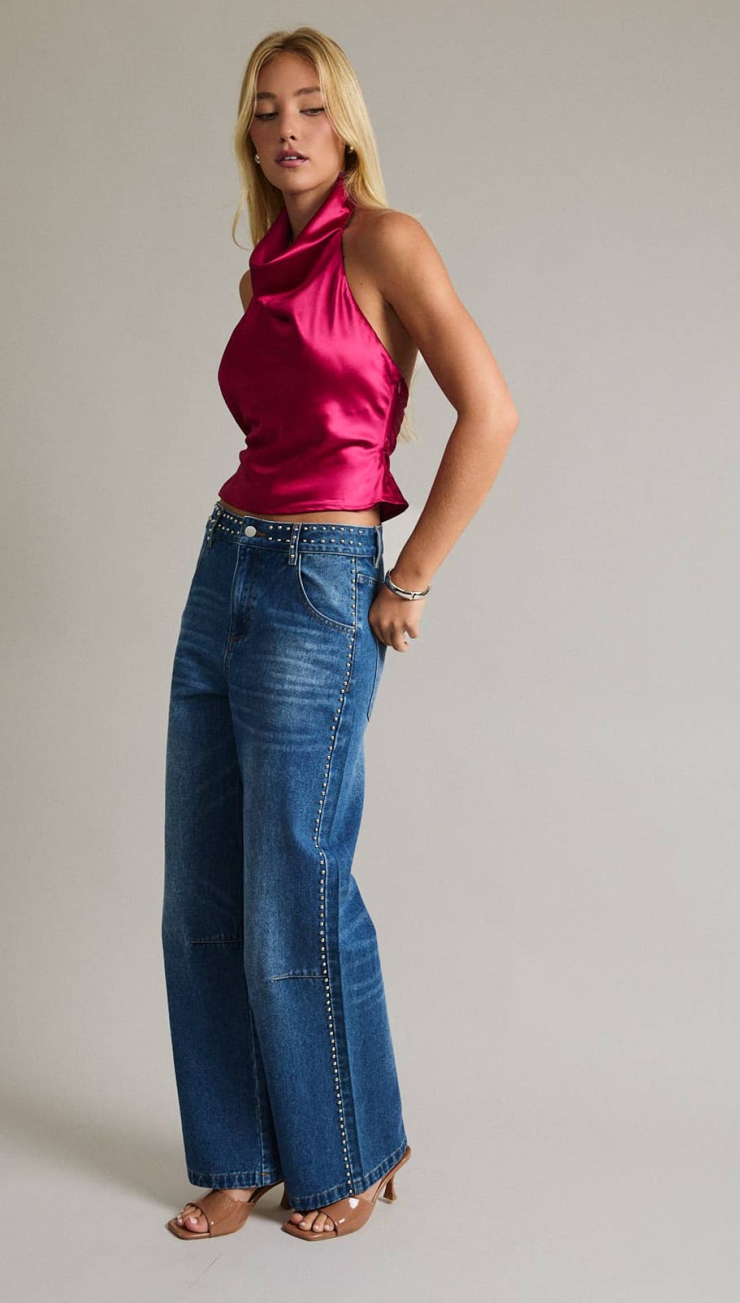 A vibrant fuchsia satin halter top with a cowl neckline and ruched back.