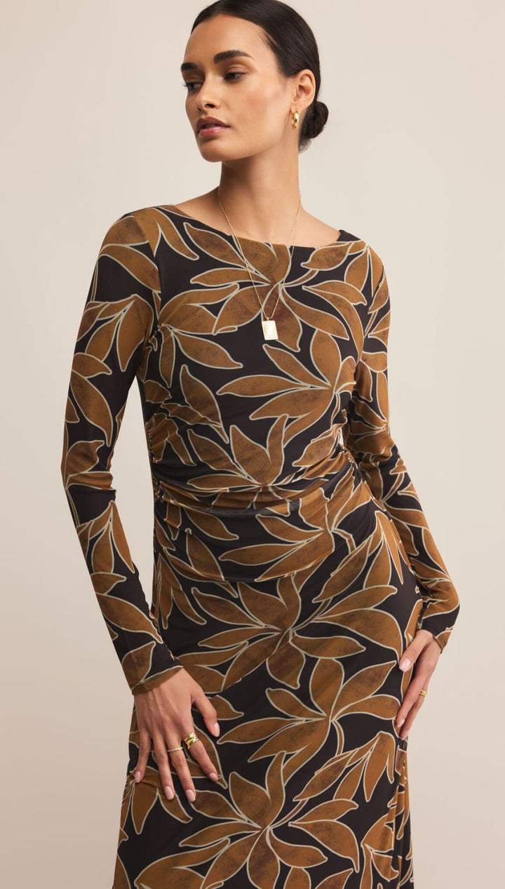 Black and gold floral print dress with long sleeves.